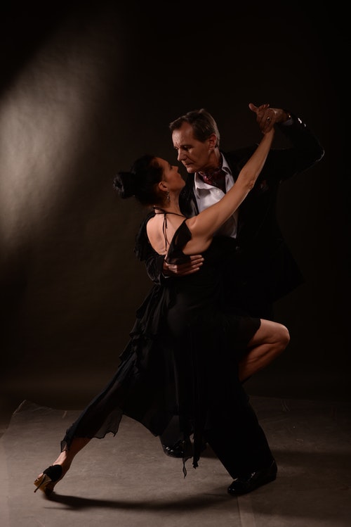 Adult tango dance class - couples learning Argentine tango in close embrace
